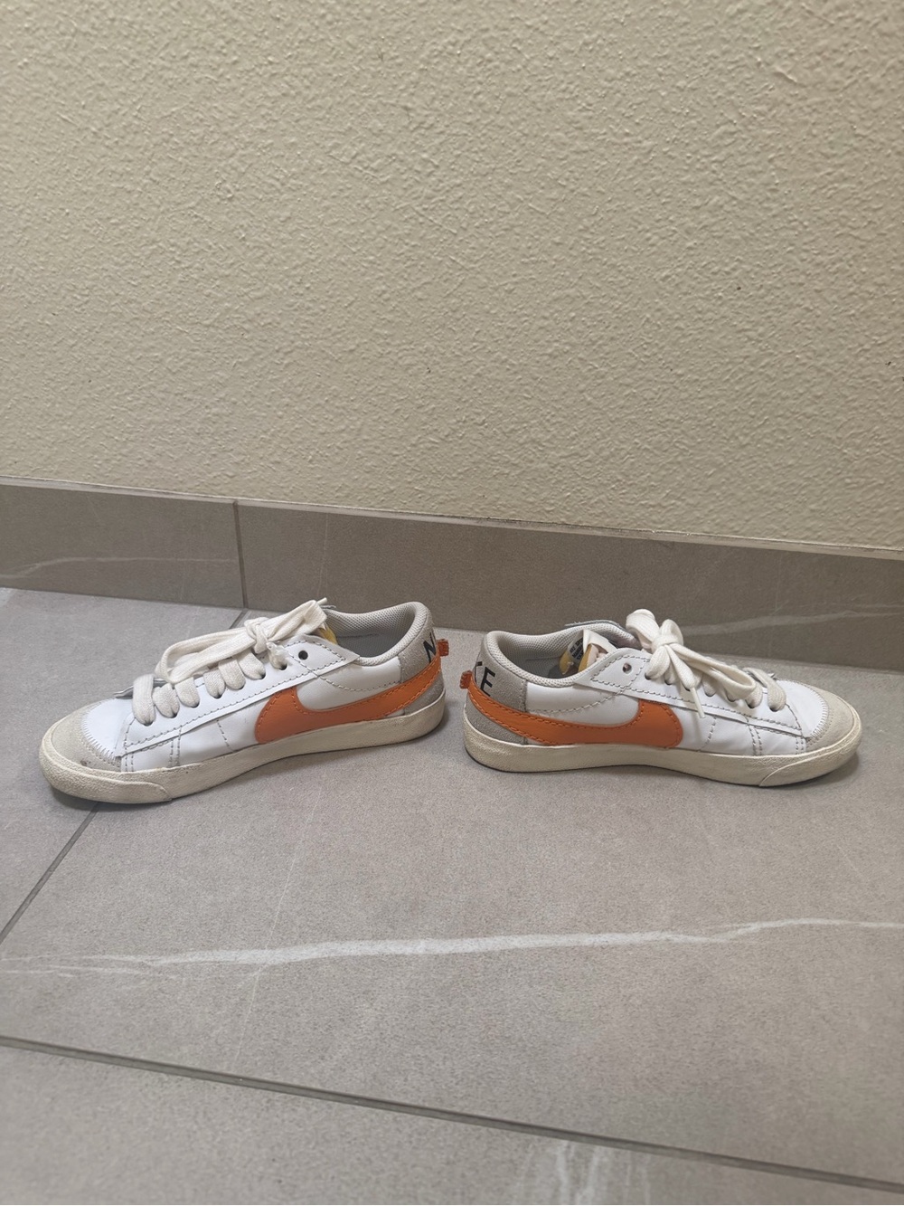Nike White Low-Top Sneakers with Orange Swoosh